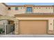 Charming home featuring a tan facade, two-car garage, and gated front entry at 3820 E Mcdowell Rd # 102, Phoenix, AZ 85008