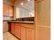 Kitchen view showcasing wood cabinets, granite counters, and a pass-through to the living area at 3820 E Mcdowell Rd # 102, Phoenix, AZ 85008