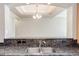 Close-up view of the granite countertop and stainless steel sink with views into living space at 3820 E Mcdowell Rd # 102, Phoenix, AZ 85008