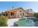 Backyard view showcasing the pool with rock features alongside the house's exterior at 3898 E San Remo Ave, Gilbert, AZ 85234