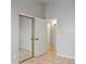 Bedroom with neutral walls, tile floor, mirrored closet doors, and an adjacent open doorway to the ensuite bath at 3898 E San Remo Ave, Gilbert, AZ 85234