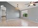 Bright dining room with tile floors, gray walls, a modern chandelier, and a view to the exterior at 3898 E San Remo Ave, Gilbert, AZ 85234