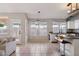 Spacious kitchen with a door to the patio, barstool seating, and ample natural light at 3898 E San Remo Ave, Gilbert, AZ 85234