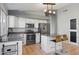 Well-equipped kitchen with a central island, granite countertops, and modern appliances at 3898 E San Remo Ave, Gilbert, AZ 85234