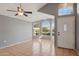 Living room with tile floors, gray walls, front door, a ceiling fan, and many windows at 3898 E San Remo Ave, Gilbert, AZ 85234
