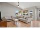 Living room featuring tile floors, gray walls, a ceiling fan, and a large sectional sofa at 3898 E San Remo Ave, Gilbert, AZ 85234