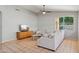 Living room with tile floors, gray walls, a ceiling fan, and a large sectional sofa at 3898 E San Remo Ave, Gilbert, AZ 85234