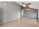 Living room with tile floors, gray walls, a ceiling fan, and an archway to another room at 3898 E San Remo Ave, Gilbert, AZ 85234