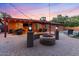Inviting backyard with a cozy fire pit, outdoor seating, and string lights for evening entertainment at 3919 S Siesta Ln, Tempe, AZ 85282