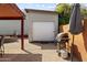 Backyard featuring a shed with roll-up door, barbeque grill, and covered patio with string lights at 3919 S Siesta Ln, Tempe, AZ 85282