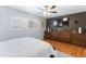 Spacious bedroom featuring wood floors, large built-in cabinet, and a modern ceiling fan at 3919 S Siesta Ln, Tempe, AZ 85282
