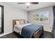 Well-lit bedroom with a large window, wood-look flooring, and a stylish ceiling fan at 3919 S Siesta Ln, Tempe, AZ 85282