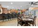 Open kitchen and dining area featuring granite countertops, stainless appliances, and barstool seating at 3919 S Siesta Ln, Tempe, AZ 85282