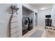 Organized laundry room with modern washer and dryer, built-in shelving, and ample storage space at 3919 S Siesta Ln, Tempe, AZ 85282