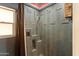 Custom shower featuring modern fixtures, unique tile accents, and convenient built-in shelving at 3919 S Siesta Ln, Tempe, AZ 85282