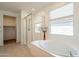 Bathroom features a walk-in shower, soaker tub, and a window for natural light at 4084 E Caitlin Dr, San Tan Valley, AZ 85140