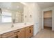 Stylish bathroom with double sinks, neutral tile, and a view of the glass enclosed shower in the mirror at 4084 E Caitlin Dr, San Tan Valley, AZ 85140
