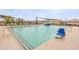 Community pool features ample lounge chairs and sunshades, offering a relaxing and enjoyable space for residents at 4084 E Caitlin Dr, San Tan Valley, AZ 85140