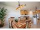 Well-lit dining area with modern lighting, tile floors and views into the kitchen with stainless steel appliances at 4084 E Caitlin Dr, San Tan Valley, AZ 85140