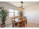 Elegant dining area featuring a wooden table with seating for eight and modern pendant lighting at 4084 E Caitlin Dr, San Tan Valley, AZ 85140