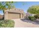 Charming single-story home featuring a brick driveway, two-car garage, and desert landscaping at 4084 E Caitlin Dr, San Tan Valley, AZ 85140