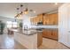 Kitchen view with island, granite countertops, wooden cabinets and modern appliances with breakfast nook nearby at 4084 E Caitlin Dr, San Tan Valley, AZ 85140