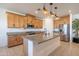 Spacious kitchen featuring granite countertops, stainless steel appliances, and a center island with stylish pendant lighting at 4084 E Caitlin Dr, San Tan Valley, AZ 85140