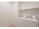 Functional laundry room equipped with a side-by-side washer and dryer set and overhead storage shelf at 4084 E Caitlin Dr, San Tan Valley, AZ 85140