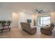 Inviting living room with tile floors, neutral walls, and comfortable seating, flowing to the outdoor patio at 4084 E Caitlin Dr, San Tan Valley, AZ 85140