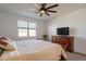 Main bedroom features carpet, a ceiling fan, a TV, and a window providing natural light at 4084 E Caitlin Dr, San Tan Valley, AZ 85140
