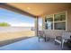 Relaxing covered patio with seating area overlooking the private backyard, perfect for outdoor entertaining at 4084 E Caitlin Dr, San Tan Valley, AZ 85140