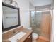 Modern bathroom featuring a glass-enclosed shower, granite countertop, and stylish vanity at 4841 W Mercer Ln, Glendale, AZ 85304