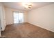 Bedroom with sliding glass doors to a patio with lush carpet at 4841 W Mercer Ln, Glendale, AZ 85304