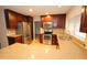 Modern kitchen with dark cabinets, stainless steel appliances, and granite countertops at 4841 W Mercer Ln, Glendale, AZ 85304