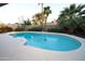 Relaxing backyard oasis featuring a sparkling blue pool, lush greenery, and mature landscaping at 4841 W Mercer Ln, Glendale, AZ 85304