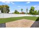 Expansive backyard featuring lush green grass, paver patio, and a privacy wall at 4916 E Flower St, Phoenix, AZ 85018