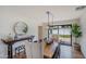 Bright dining room with a wooden table, modern lighting, and access to the backyard at 4916 E Flower St, Phoenix, AZ 85018