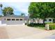Traditional home with a brick driveway, a two-car garage, and lush green landscaping at 4916 E Flower St, Phoenix, AZ 85018