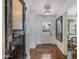 Inviting foyer with hardwood floors, a decorative door, and stylish decor leading into other living areas at 4916 E Flower St, Phoenix, AZ 85018