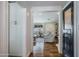 Bright hallway leading to a cozy living room, showcasing hardwood floors and white cabinets at 4916 E Flower St, Phoenix, AZ 85018