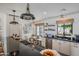 Bright kitchen featuring black countertops, modern appliances, island cooktop, and a breakfast nook at 4916 E Flower St, Phoenix, AZ 85018