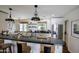 Bright kitchen featuring black countertops, modern appliances, island cooktop, and bar stool seating at 4916 E Flower St, Phoenix, AZ 85018