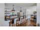 Open kitchen with a large island, a breakfast bar, hardwood floors, and stainless steel appliances at 4916 E Flower St, Phoenix, AZ 85018