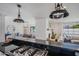 Open-concept kitchen with a black countertop island with a cooktop and views into the dining room at 4916 E Flower St, Phoenix, AZ 85018