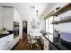 Bright kitchen featuring black countertops, modern appliances, and a breakfast nook with picture frames at 4916 E Flower St, Phoenix, AZ 85018