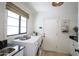 Bright laundry room with modern washer and dryer, ample counter space, and convenient storage at 4916 E Flower St, Phoenix, AZ 85018
