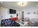 Cozy living area featuring modern lighting, comfortable seating, and access to a convenient half bathroom at 4916 E Flower St, Phoenix, AZ 85018