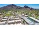 Expansive aerial view showcases homes adjacent to a manicured golf course with mountain views at 5533 E Stella Ln, Paradise Valley, AZ 85253