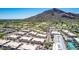 Stunning aerial view of a luxury community near a lush green golf course and majestic mountain views at 5533 E Stella Ln, Paradise Valley, AZ 85253