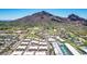 Birds-eye view highlighting luxury townhomes and a golf course community framed by a majestic mountain range at 5533 E Stella Ln, Paradise Valley, AZ 85253